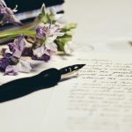 Purple flowers and document - Photo by Debby Hudson on Unsplash